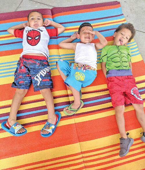 Dawud hangs out with his friends Aiden and Gage on the playground.