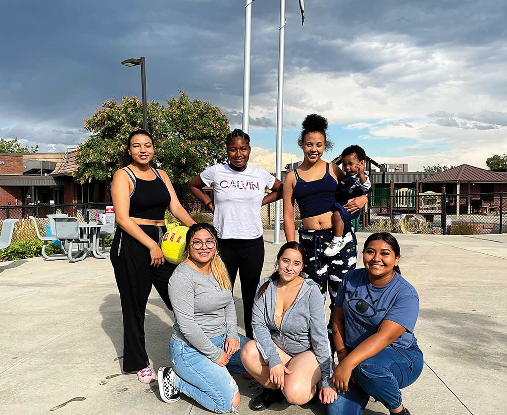 Teen moms play volleyball after school.